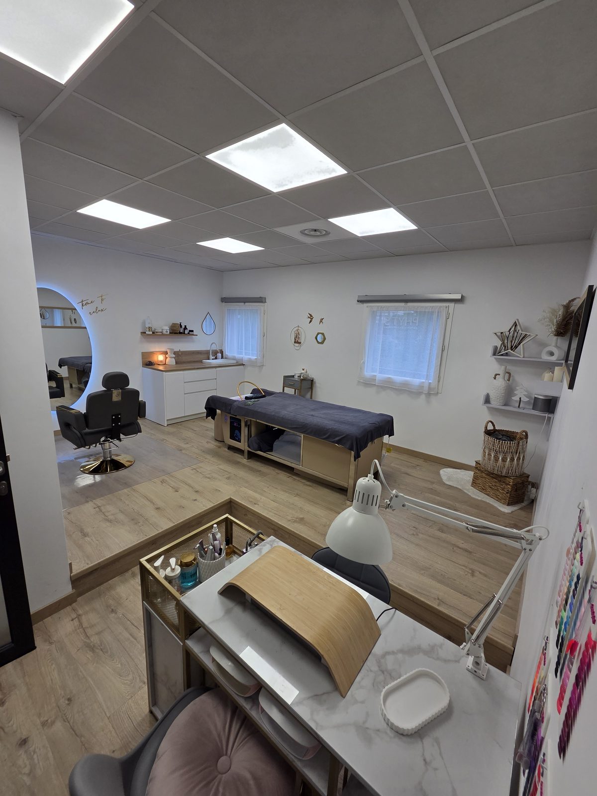 Vue large d’une cabine de soin esthétique lumineuse et épurée